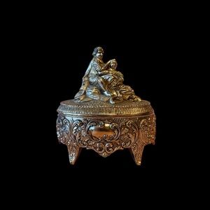 Vintage bronze music box featuring colonial couple